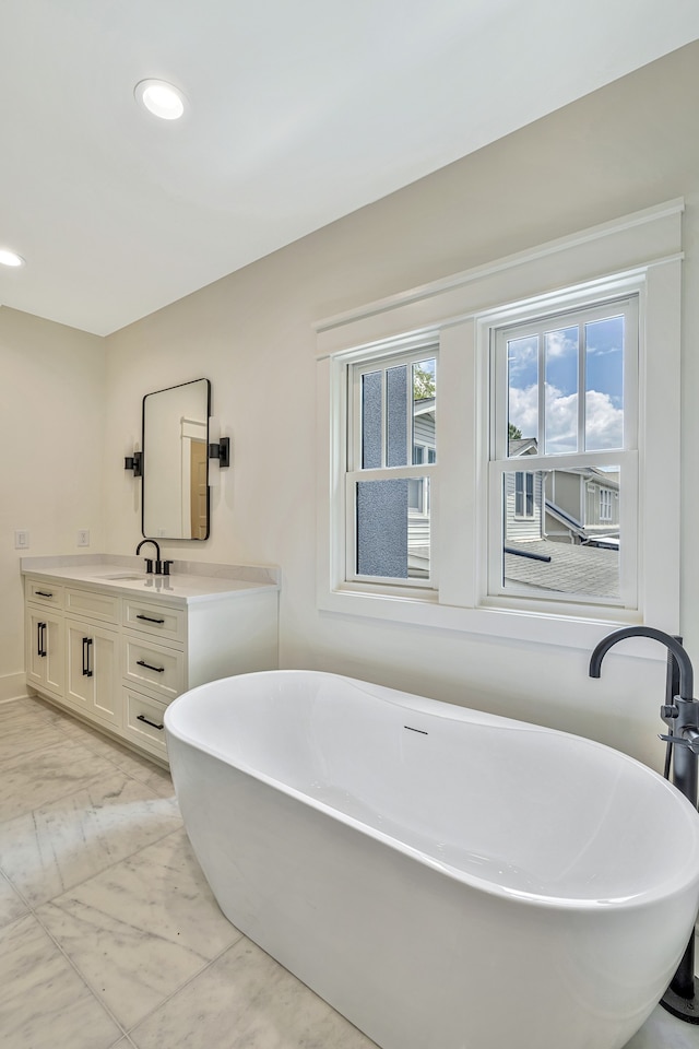 bathroom with vanity and a bathtub