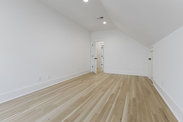 bonus room featuring lofted ceiling and light wood-type flooring