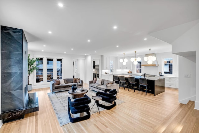 living room with a wealth of natural light and light hardwood / wood-style floors