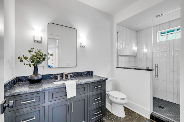 bathroom with vanity, tile patterned flooring, a shower with shower door, and toilet