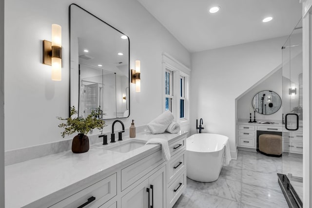 bathroom with vanity and shower with separate bathtub