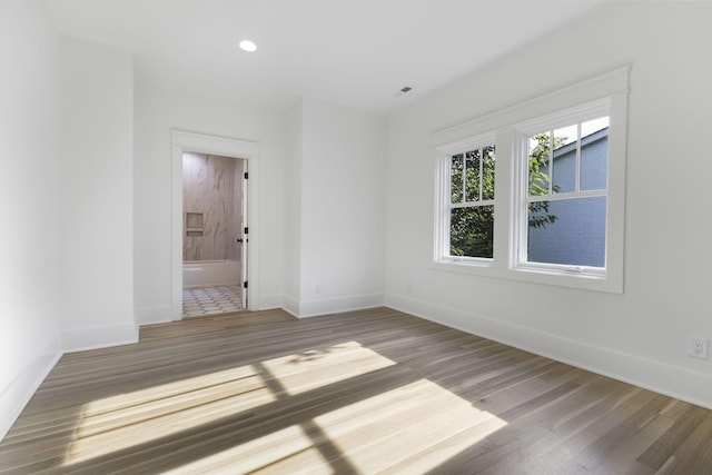 spare room with hardwood / wood-style floors