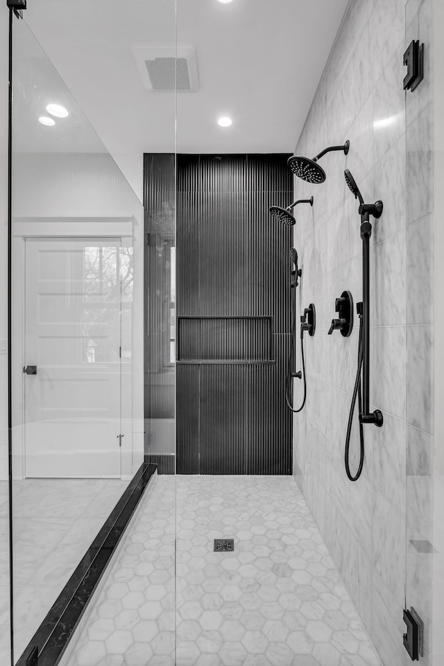 bathroom featuring tile patterned flooring and a shower with shower door