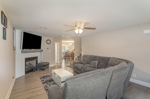 living room with ceiling fan and wood-type flooring