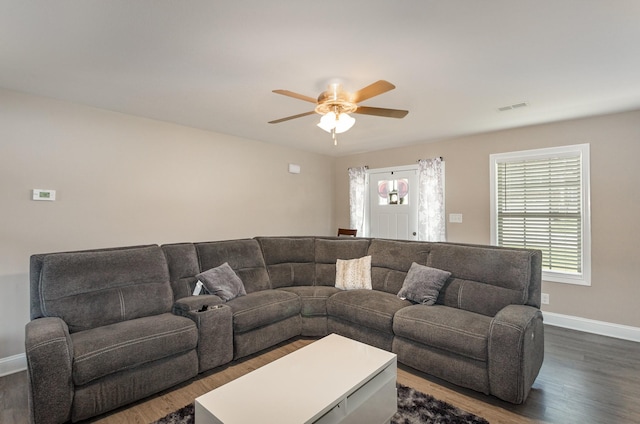 living room with ceiling fan and dark hardwood / wood-style floors