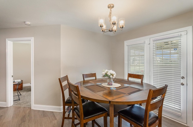 dining area with a chandelier and hardwood / wood-style floors