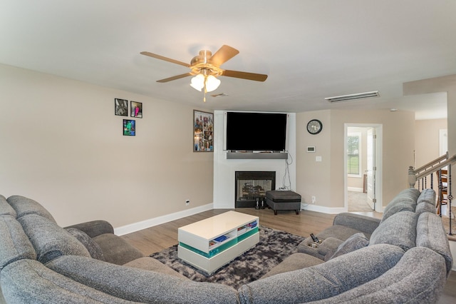 living room featuring ceiling fan and wood-type flooring