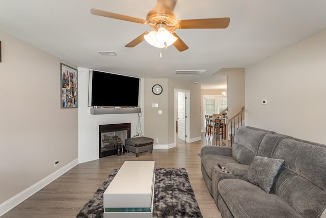 living room featuring ceiling fan and wood-type flooring