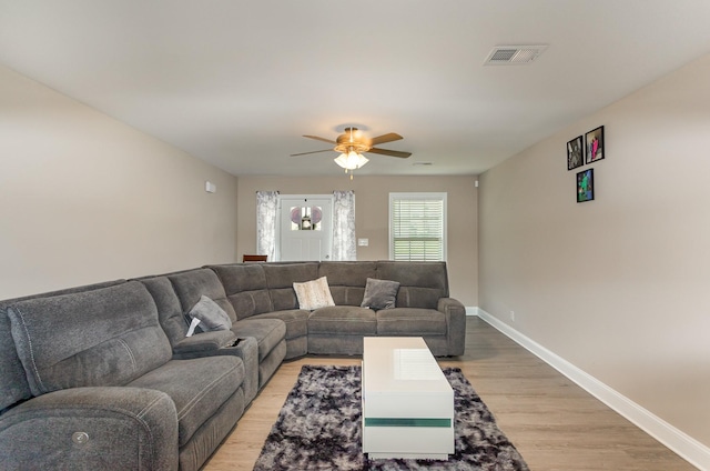 living room featuring ceiling fan and light wood-type flooring