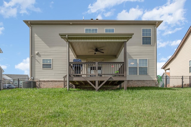 rear view of property with ceiling fan, cooling unit, a lawn, and a deck