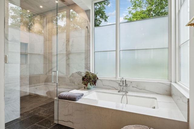 bathroom featuring tile patterned floors and shower with separate bathtub