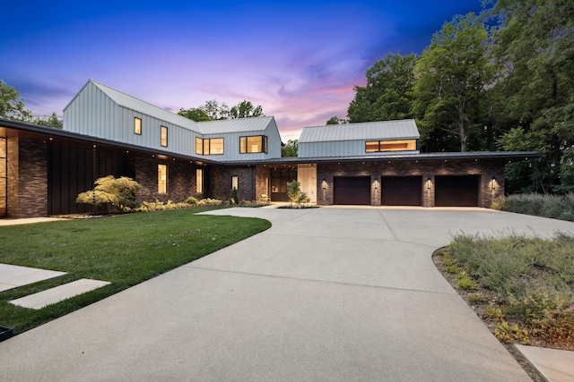 view of front of house with a garage and a yard