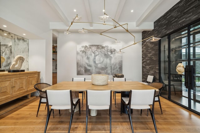 dining space with hardwood / wood-style floors and beam ceiling