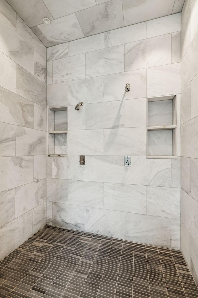 bathroom with a tile shower