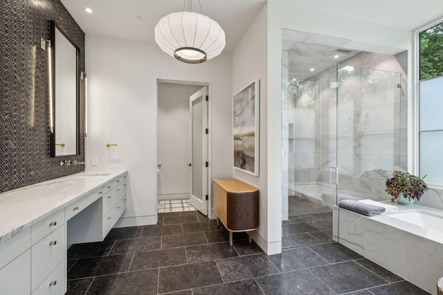 bathroom with vanity and independent shower and bath