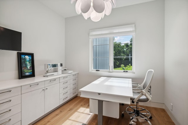 home office with light hardwood / wood-style floors