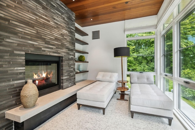 interior space featuring a large fireplace and wooden ceiling