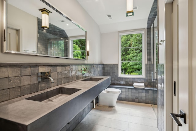 bathroom featuring tile patterned flooring, vanity, a shower with shower door, and toilet