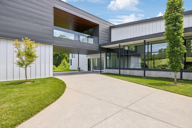 rear view of property featuring a yard