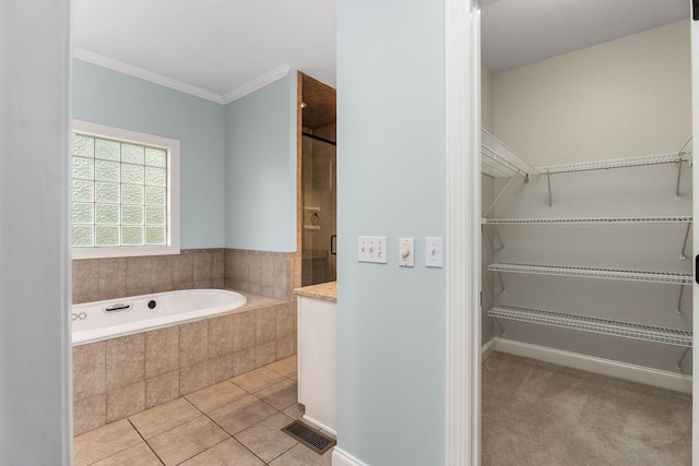 bathroom featuring visible vents, a tile shower, a bath, tile patterned floors, and crown molding