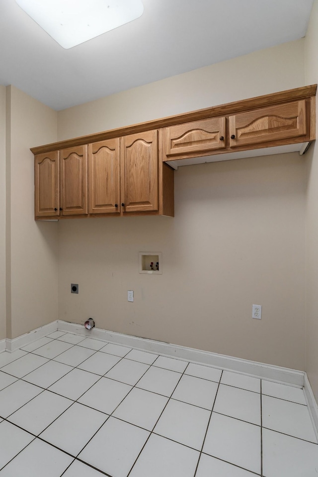 laundry area with light tile patterned floors, washer hookup, baseboards, cabinet space, and electric dryer hookup