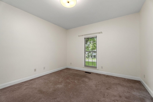 carpeted empty room with baseboards