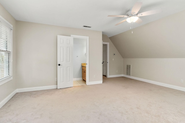 bonus room featuring light carpet, visible vents, vaulted ceiling, and a ceiling fan