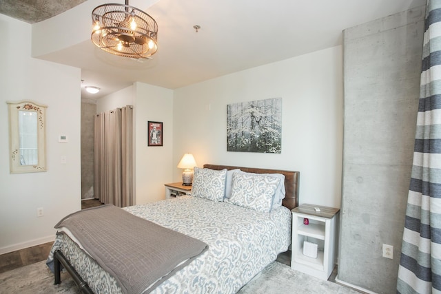 bedroom with a chandelier and hardwood / wood-style flooring