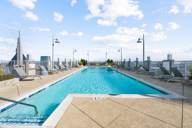 view of swimming pool featuring a patio area