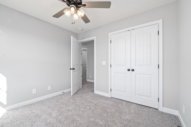 unfurnished bedroom featuring a closet, ceiling fan, and light colored carpet