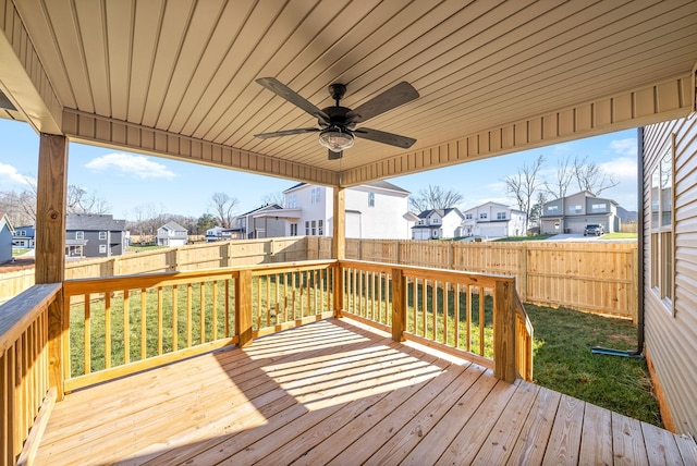 wooden deck featuring ceiling fan and a yard