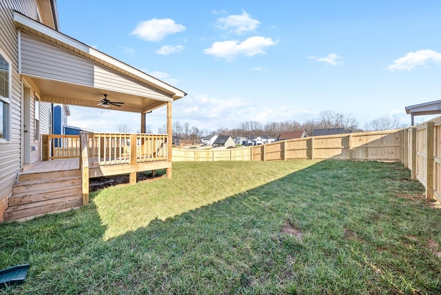 view of yard featuring ceiling fan and a deck