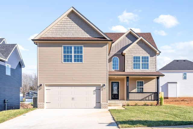 view of front of property with a porch, a garage, and a front lawn