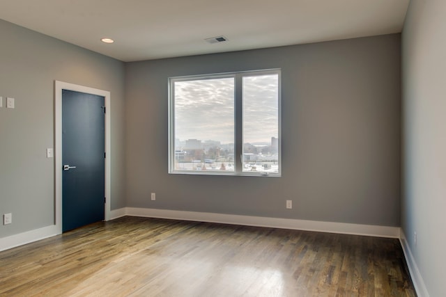 spare room with hardwood / wood-style flooring