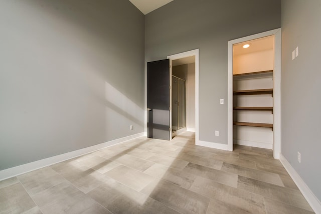 unfurnished bedroom with a walk in closet and a closet