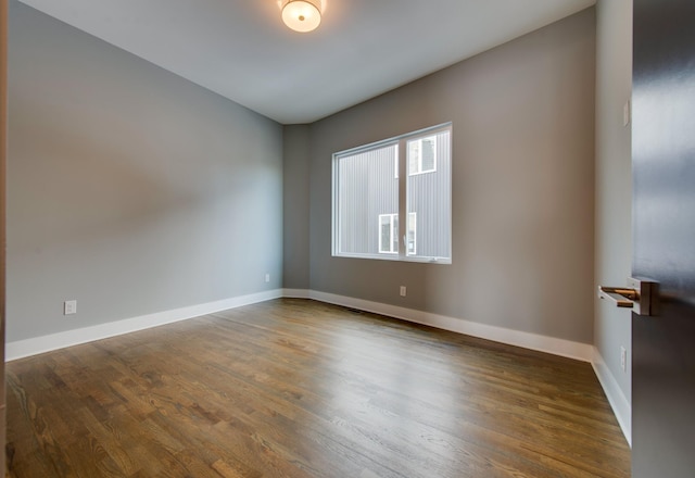 spare room with dark wood-type flooring