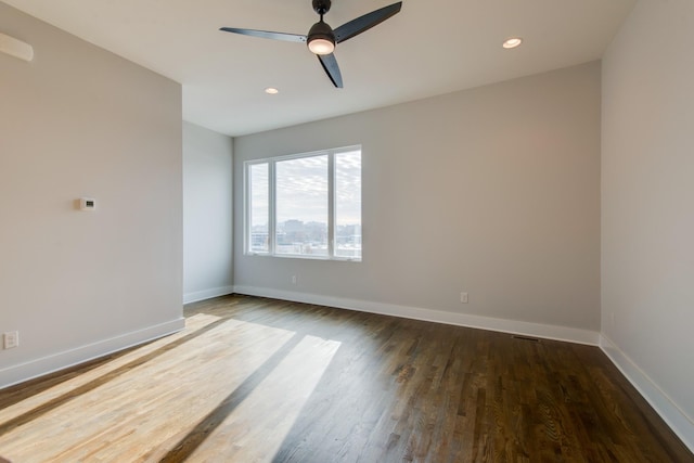 empty room with dark hardwood / wood-style floors and ceiling fan