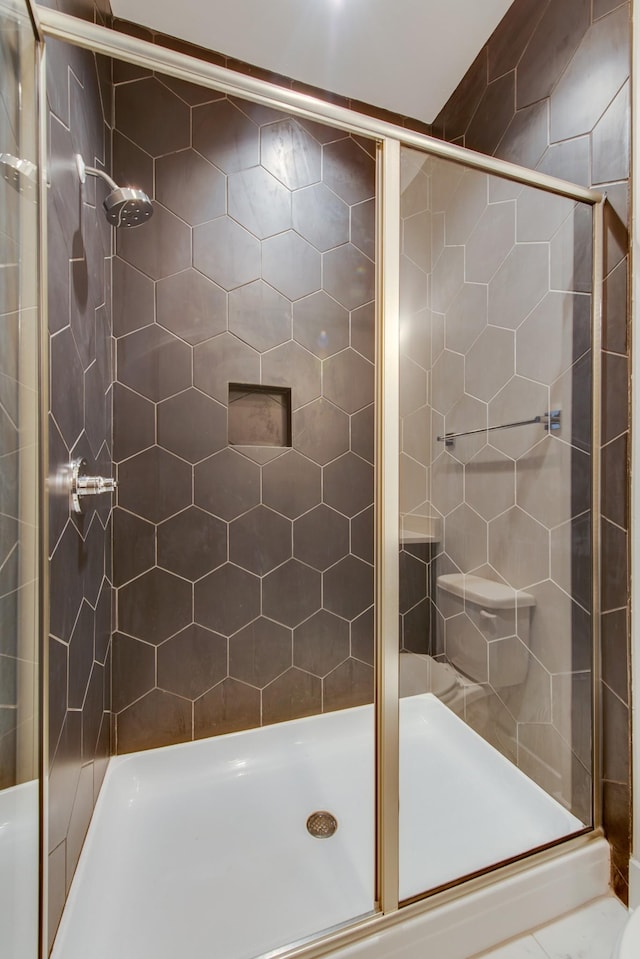 bathroom with a shower with door