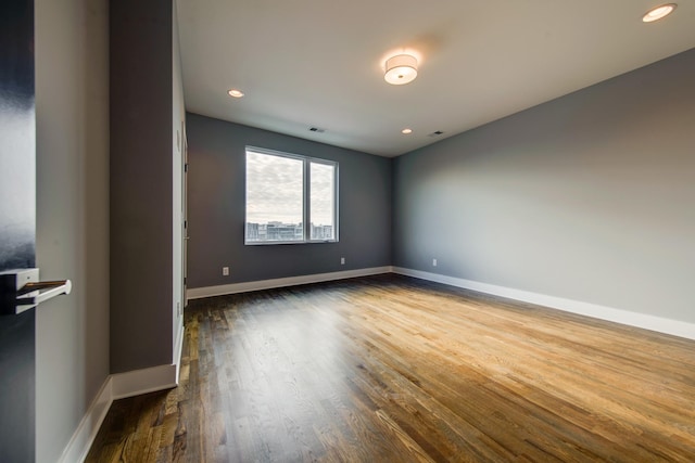 empty room featuring dark wood-type flooring