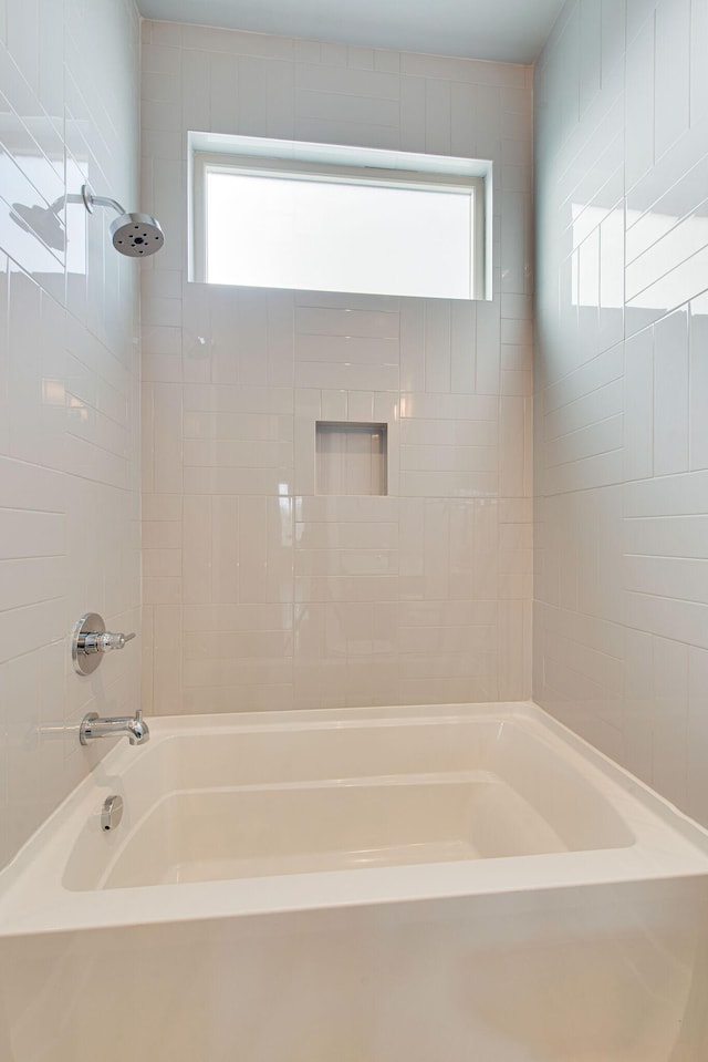 bathroom featuring a wealth of natural light and shower / washtub combination