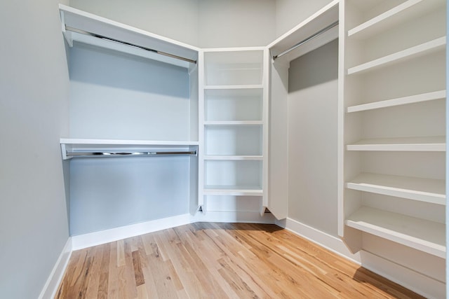 spacious closet featuring light hardwood / wood-style floors