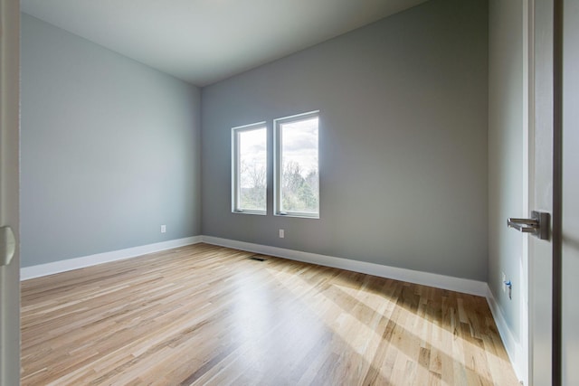 spare room with light hardwood / wood-style flooring