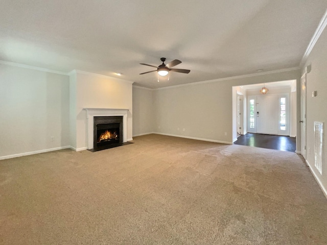 unfurnished living room with carpet flooring, ceiling fan, and ornamental molding