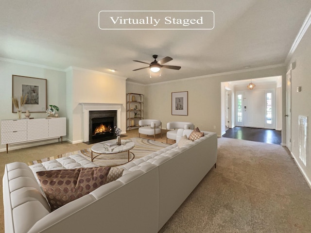 carpeted living room featuring ceiling fan and ornamental molding