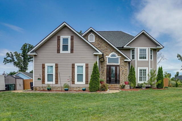 view of front of home featuring a storage unit and a front lawn