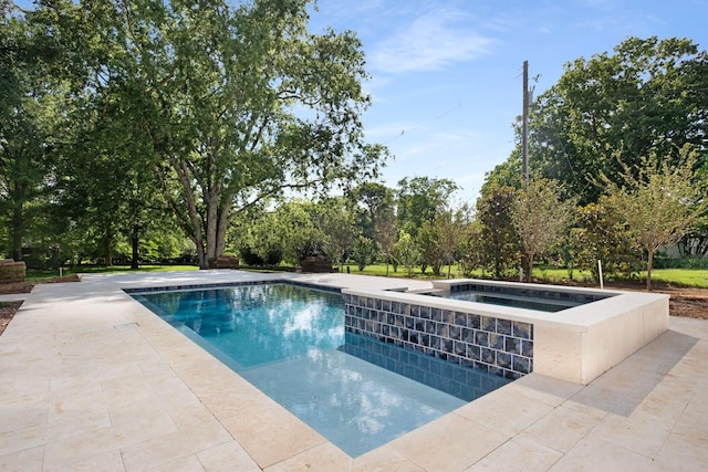 view of pool featuring a patio area and an in ground hot tub