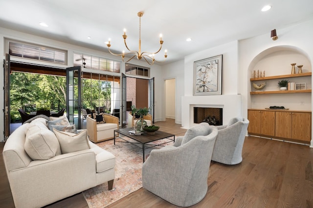 living room featuring dark wood-type flooring and an inviting chandelier