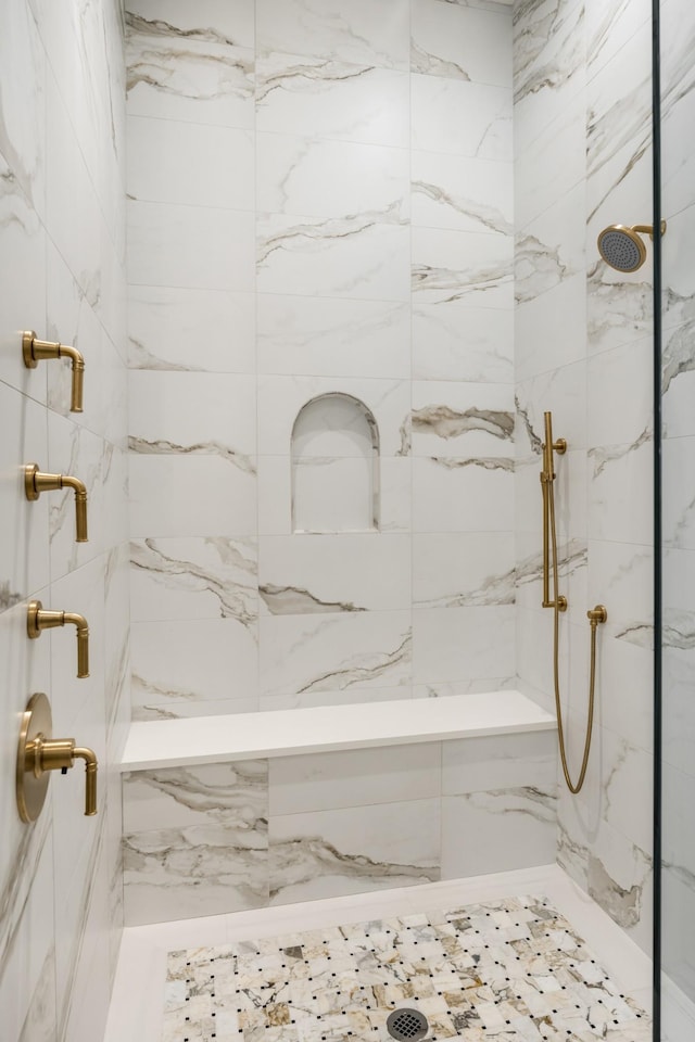 bathroom with a tile shower