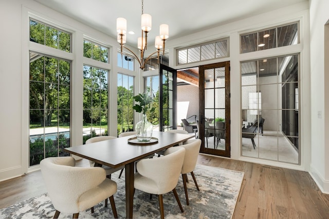 sunroom featuring a chandelier