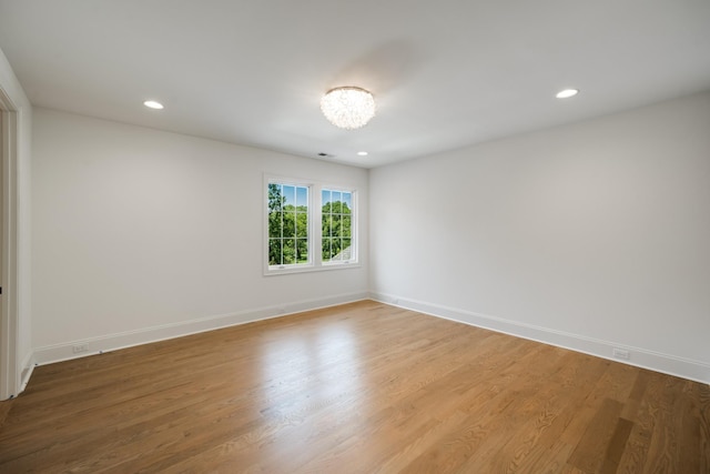 spare room with hardwood / wood-style flooring